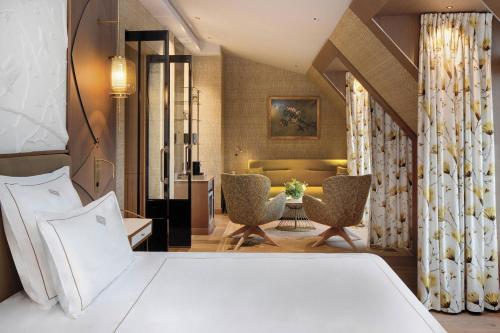 a bedroom with a bed and a living room at La Demeure Montaigne in Paris