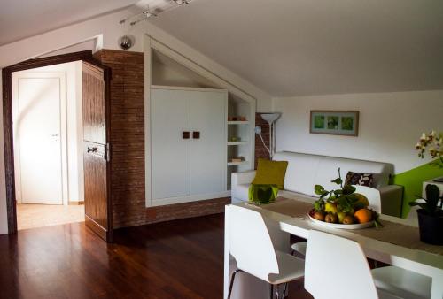 a kitchen and living room with a table and chairs at Residence Zelzar in Vietri sul Mare