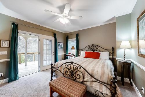 a bedroom with a bed and a ceiling fan at Above the River in Sylva