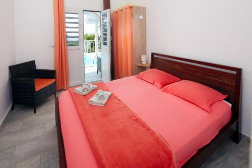 Postel nebo postele na pokoji v ubytování Villa Corail