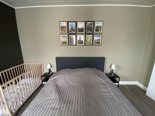 a bedroom with a bed with two night stands and two lamps at Cosy vacation home for 8 persons in Heers