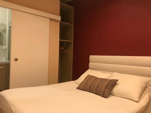 a bedroom with a bed with a pillow on it at Logis Le Cheval Blanc in Saint-Just