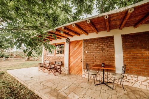 a patio with chairs and a table and a building at Hotel Fundo El Arrabal in Ica
