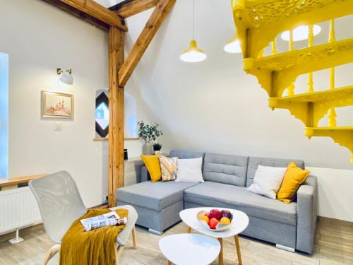 a living room with a blue couch and a table at Wroclaw Inn Apartments in Wrocław