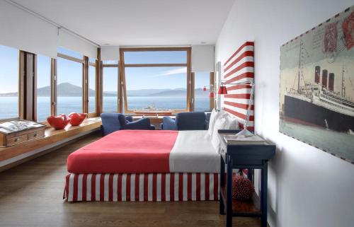 a bedroom with a bed and a view of the ocean at Maison La Minervetta in Sorrento