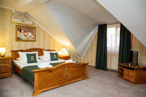a bedroom with a large bed and a television at Zolota Pava in Berehove