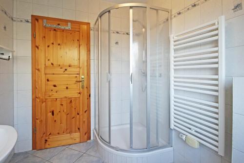 a shower with a glass door in a bathroom at Ostseetraum Wohnung EG in Wittenbeck