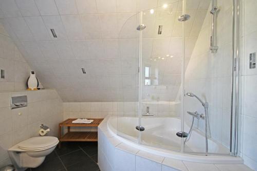 a bathroom with a shower and a tub and a toilet at Ostseetraum Wohnung OG in Wittenbeck