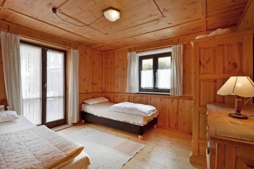 a bedroom with two beds and two windows at Haus Gerdi in Söll