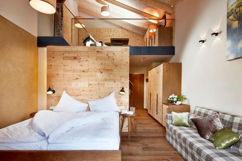 a living room with a bed and a couch at Gut Sonnberghof in Mittersill