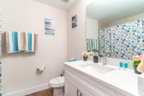a bathroom with a sink and a toilet and a mirror at 3260 Little Harbor in Ruskin