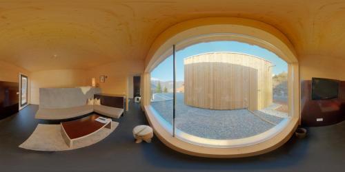 a room with a large round window in a room at Refugio Laudegg in Ladis