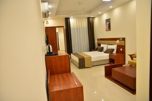 a hotel room with a bed and a desk at RED SEA HOTEL APARTMENT in Djibouti