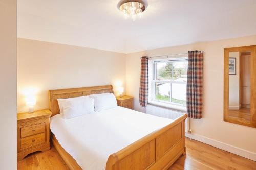 a bedroom with a large bed and a window at Host & Stay - Holmedene in Filey