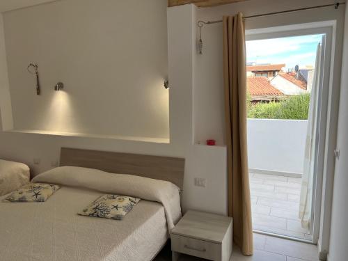 a bedroom with two beds and a large window at Al Mare da Francesca in Olbia