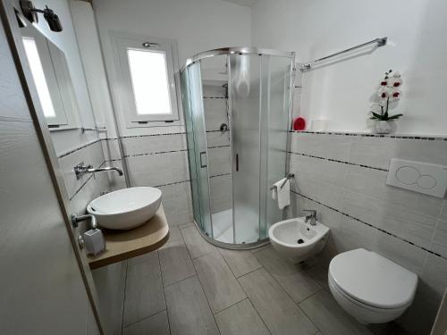 a bathroom with a shower and a toilet and a sink at Al Mare da Francesca in Olbia