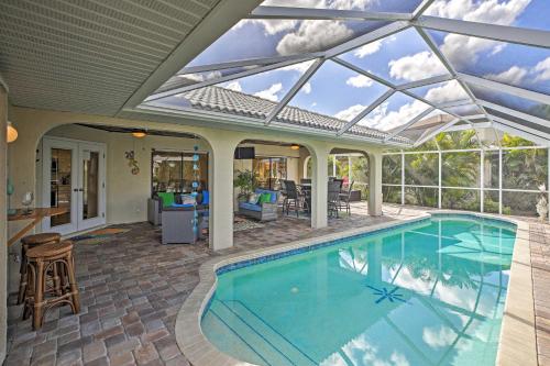 an indoor swimming pool with a glass roof at Canal Waterfront Home with Private Pool and Dock! in Punta Gorda