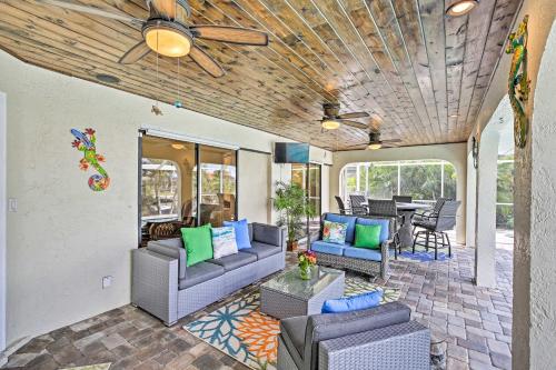 a patio with couches and a ceiling fan at Canal Waterfront Home with Private Pool and Dock! in Punta Gorda