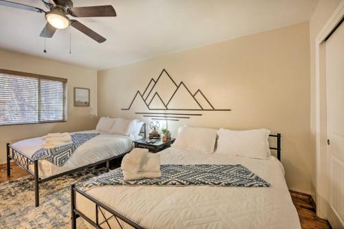 a bedroom with two beds and a ceiling fan at 32 Mi to Sunrise Park White Mountain Retreat in Indian Pine