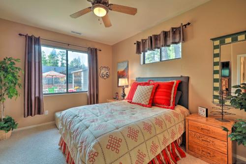 a bedroom with a bed with red pillows and a window at Vibrant Home with Patio about 60 Miles to Grand Canyon! in Williams