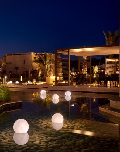 a house with a swimming pool at night at Fairmont Taghazout Bay in Taghazout