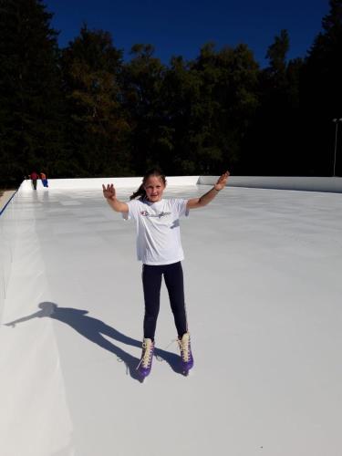 a young girl standing on top of a white surface at Landhotel Häuserl im Wald in Gröbming