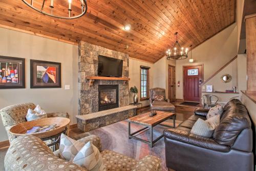 a living room with leather furniture and a stone fireplace at Pelican Lake Retreat with Fire Pit, Dock and Grill! in Breezy Point