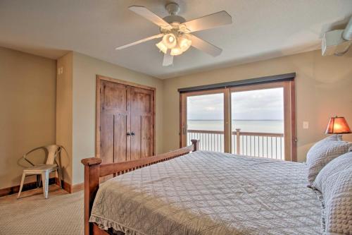 a bedroom with a bed and a ceiling fan at Pelican Lake Retreat with Fire Pit, Dock and Grill! in Breezy Point