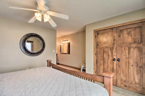 a bedroom with a ceiling fan and a wooden door at Pelican Lake Retreat with Fire Pit, Dock and Grill! in Breezy Point