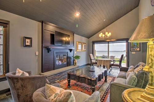 a living room with a couch and a fireplace at Breezy Point Escape with Views, Dock and Fire Pit! in Breezy Point