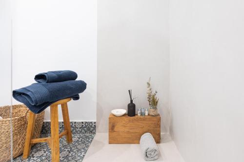 a stool with a blue towel on it in a room at PHARUS retro beach home New Heated Pool in Maspalomas