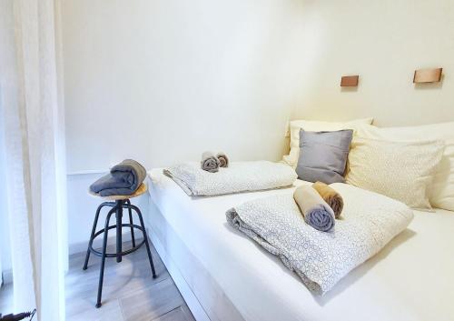 a white bed with two pillows on it at Marina Apartment by Dora in Keszthely