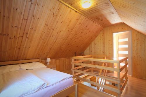 a bedroom with a bunk bed in a wooden cabin at Ośrodek Wczasowy Łowiczanka in Wisełka