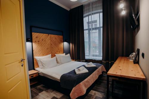 a hotel room with a bed and a window at Gutenberg Hotel in Saint Petersburg
