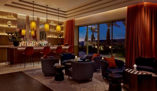 a bar in a hotel with chairs and a counter at Fairmont Taghazout Bay in Taghazout