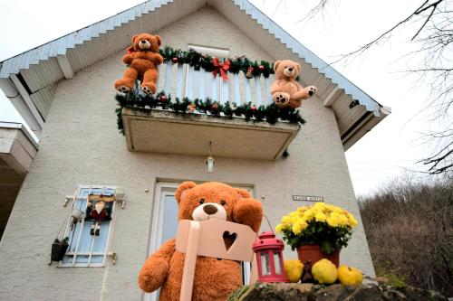 a house with stuffed teddy bears on a balcony at Honey hill apartment Fruska Gora in Čerević
