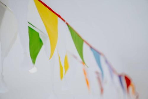 a bunch of colorful flags hanging on a string at The Nook in Barnstaple