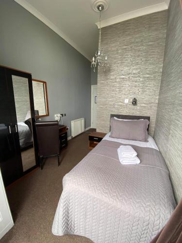 a bedroom with a large bed and a mirror at The Lansdowne in Hastings