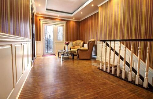 a hallway with a staircase with a chair and a table at Sanata in Tbilisi City