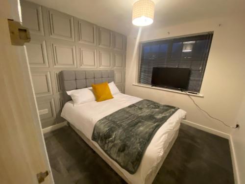 a bedroom with a bed and a window and a television at Westpoint in Derby