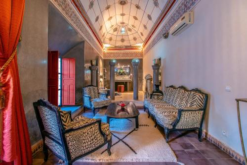 a living room with couches and a table at Prestige du Souss in Oulad Berhil