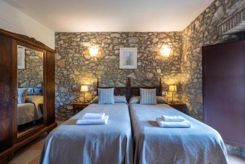 a bedroom with a bed with two pillows on it at Can Llobet in Capmany