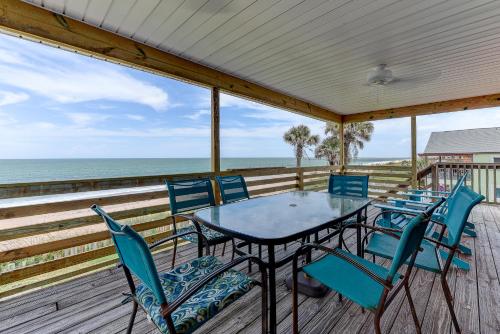 Una mesa y sillas en una terraza con vista al mar. en Dreamview, en St. Augustine