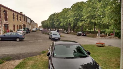 a group of cars parked in a parking lot at Chambres d'Hôtes Saint Roch in Tournecoupe