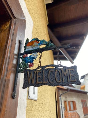 a welcome sign on the side of a building at Casa Mia Fiemme in Carano