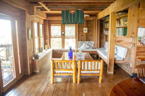 a room with two chairs and a table in a cabin at Roatan Bed & Breakfast Apartments in West End