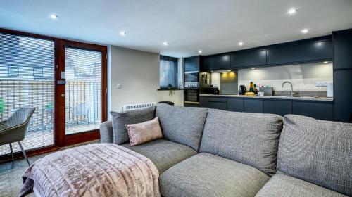 a living room with a couch and a kitchen at The Courtyard Apartment in Brampton