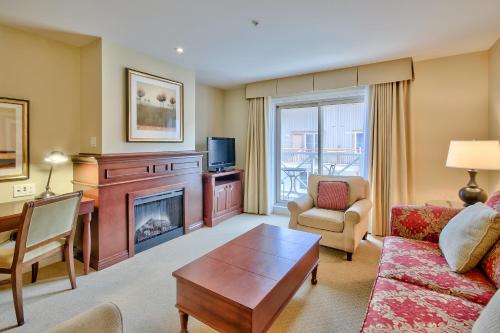 a living room with a couch and a fireplace at Residences at the Sun Peaks Grand in Sun Peaks