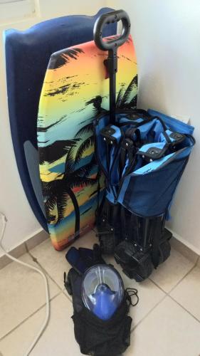 a surfboard and an umbrella sitting on the floor at Breezy Nights Puerto Rico in Loiza