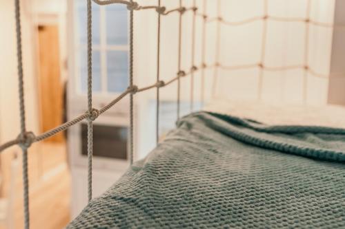 a close up of a metal bed in a room at Apartament Dar Pomorza 20m do Plaży Ustronie Apartments in Ustronie Morskie